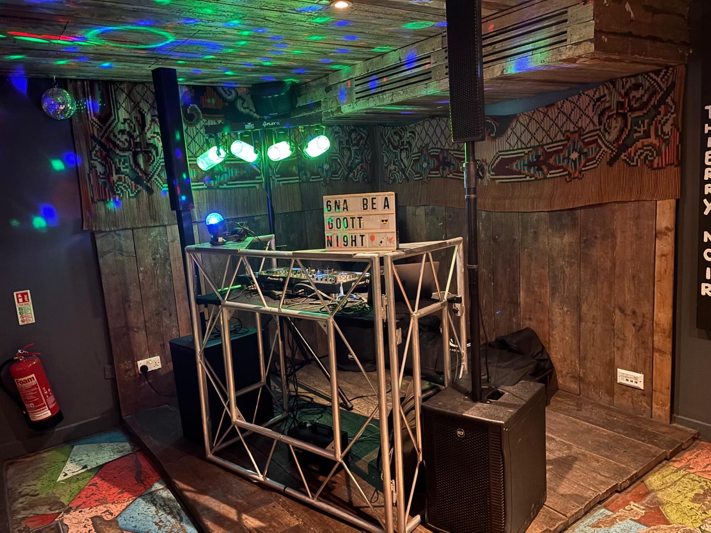 Smart DJ booth with lighting rig set up in a venue
