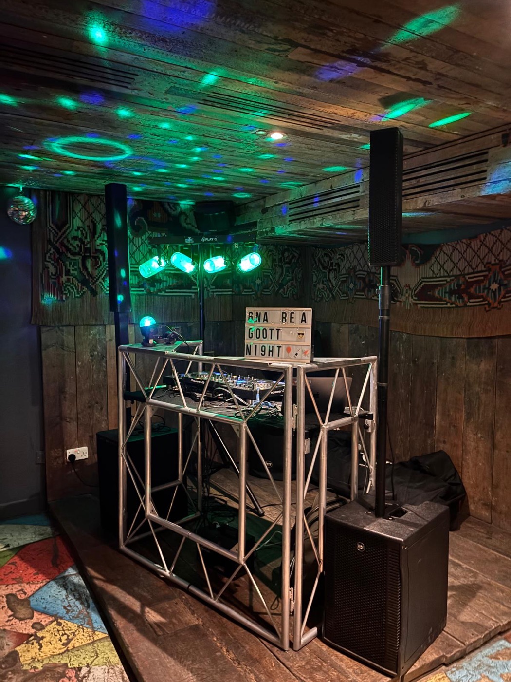 DJ booth lit in teal and green
