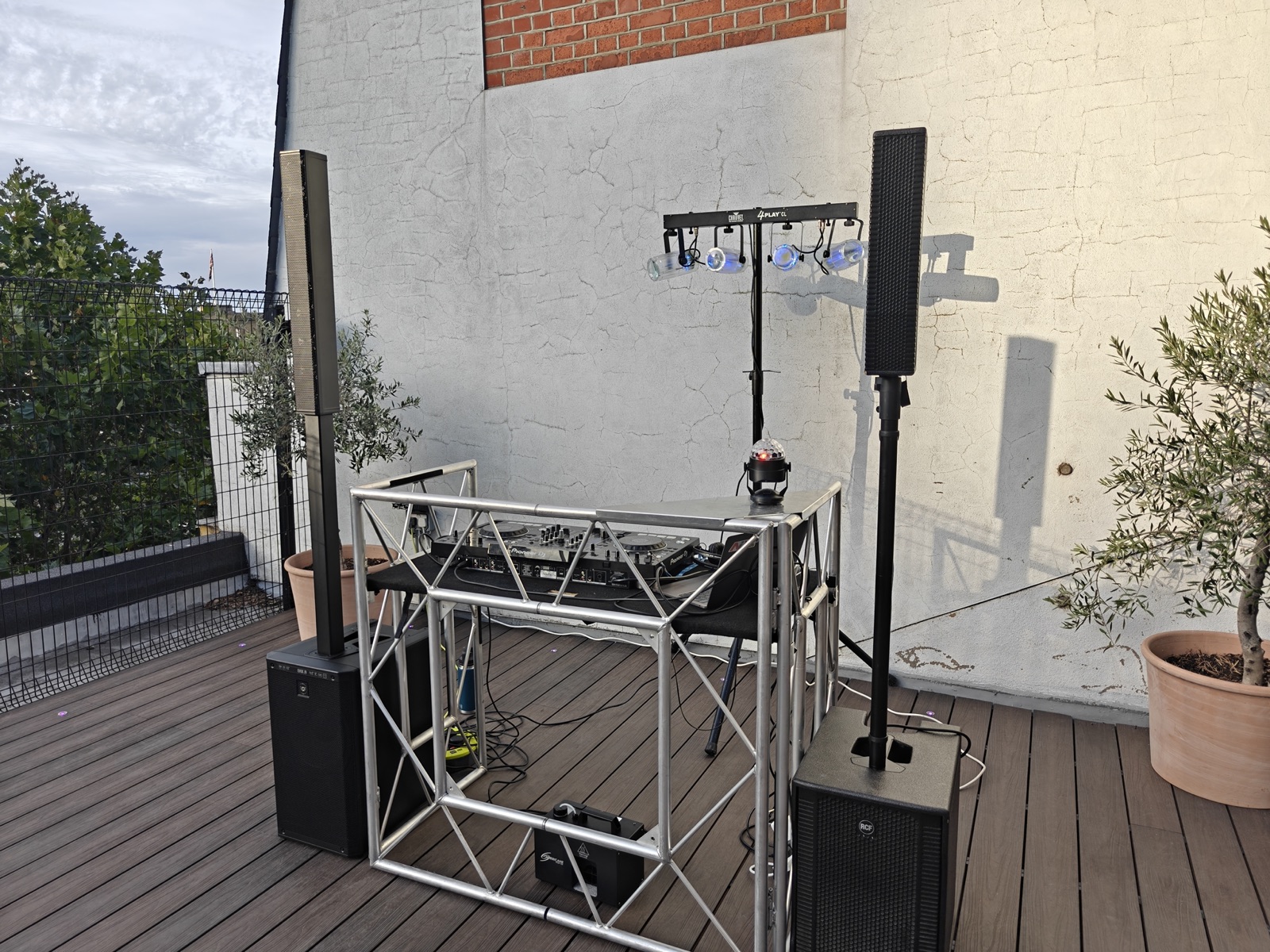 Outdoor rooftop DJ setup at dusk